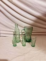 All five green Coca-Cola glass pieces grouped