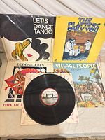 All five LP sleeves displayed with one record outside sleeve