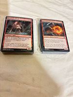 Two shrink-wrapped stacks of the foil cards