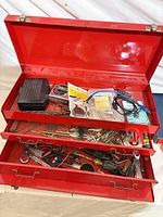 overview of red toolbox open with contents visible in drawers