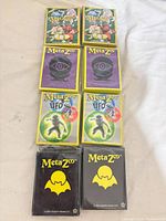 Front view of all eight sealed MetaZoo sleeve packs showing artwork variations