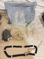 Entire lot with fabric pouch, multiple bags of beads and necklaces laid out