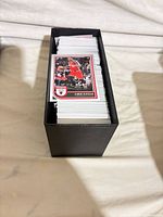 Stack of Panini Hoops cards inside black storage box