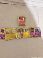 Spread and stack of yellow-border Pokémon cards