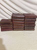 Front view of 16 burgundy Reader's Digest Condensed Books stacked in two columns