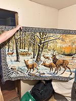 Full view of the woven wall hanging held up to show size, design and border