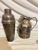 Shaker and pitcher front view showing overall form and tarnish