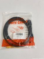 Sealed package showing coiled black cable with HDMI connector and three RCA connectors