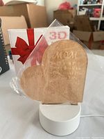Lamp assembled showing acrylic heart panel in base with packaging behind