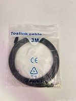 Front of sealed package showing coiled 3 m Toslink cable