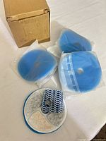 Four sealed blue foam discs, round multi-media pad, square honeycomb pad with shipping box