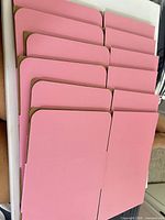Stack of six flat pink box blanks