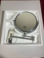 Mirror in foam packaging showing 7x mark and arm