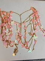 Overall necklace layout showing chains, butterfly charms, and heart tag extender