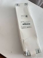 Front of white Alex Tech box with barcode label and visible creases