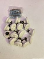 Set of 12 ceramic knobs with floral tops and brass bases, screws bagged