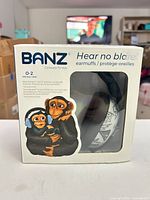 Front of boxed BANZ infant earmuffs showing product name and age range