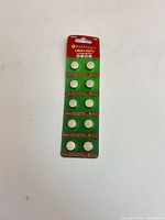 Front view of sealed blister card showing 10 button cell batteries