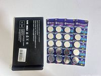 Front view of four blister cards of Beidongli CR2450 batteries beside outer box