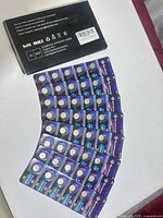 Top view of twenty blister cards containing CR1225 coin cell batteries