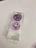 Front view of both pacifiers in packaging