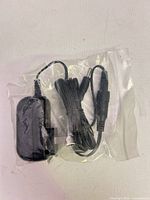 Adapter in plastic bag showing plug and cable
