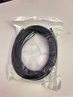 Front view of sealed coil of black rubber trim strip
