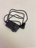 AC adapter showing US plug blades and specification label