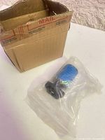 Spool in sealed bag next to shipping box
