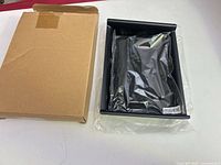 Tray in plastic sleeve inside box