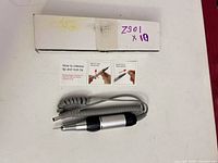 Handpiece, coiled cord, instruction cards and box overview