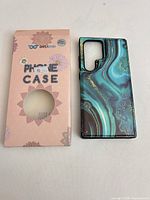 Front view of wallet phone case beside retail box