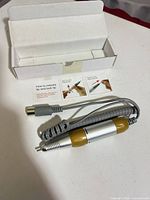 Handpiece with coiled cord, connector, instruction card and box
