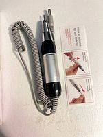 Handpiece with coiled cable and instruction card