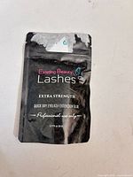 Front of Existing Beauty Lashes Extra Strength eyelash extension glue pouch