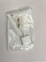 Front view of sealed white Lightning to HDMI adapter in clear plastic bag