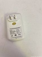 Rear view showing plug and technical label with specs