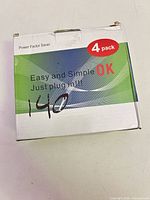 Front of sealed 4-pack box with branding and voltage info