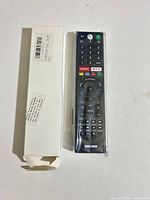 Remote control front next to white box
