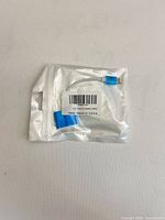Front of sealed pouch showing adapter and barcode label