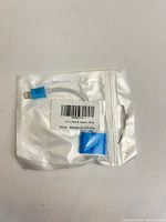 Front of sealed pouch showing adapter and label