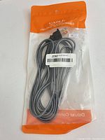 Front of sealed package showing gray braided cable and connectors