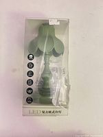 Front view of boxed green LED desk lamp