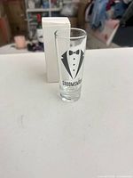 Front view of shot glass and box