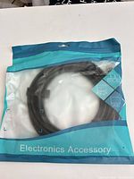 Front view of sealed package showing coiled black HDMI cable inside clear section and Electronics Accessory branding