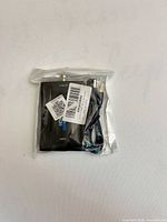 Sealed package showing HDMI to BNC converter and coiled USB power cable