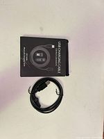 Front of retail box beside coiled cable