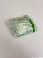Sealed plastic bag of iridescent glass gems