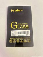 Front of ivoler tempered glass screen protector box showing brand, product type and sealed barcode label
