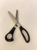 Scissors open showing blades and handles